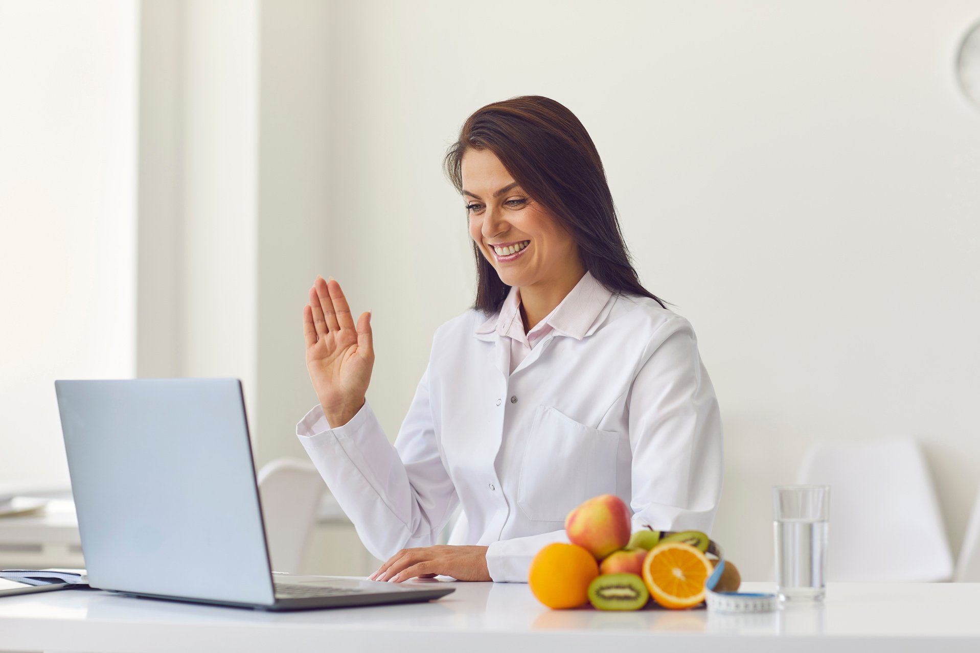 Nutritionist Uses a Laptop to Conduct an Online Consultation with His Patient.